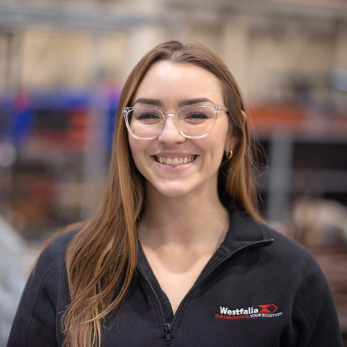 Westfalia USA employee wearing branded jacket in company workspace